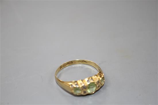 An early 20th century 18ct gold, green tourmaline and diamond chip set half hoop ring,